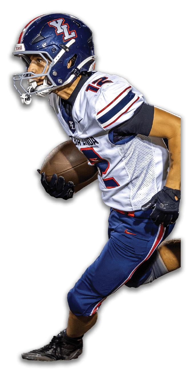 A person wearing a football uniform and helmet is running while holding a football. Description generated by AI
