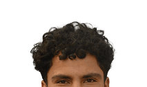 Person with short curly hair looking directly at the camera against a white background. Description generated by AI