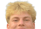 Person with short, tousled blond hair smiling against a white background. Description generated by AI