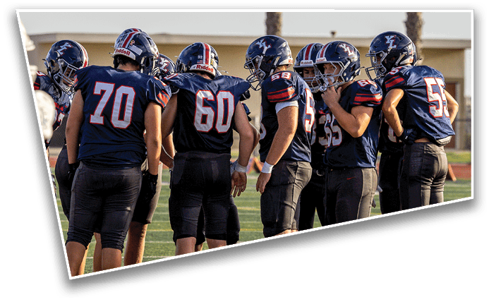 A group of people wearing sports uniforms and cleats are standing together on a football field. Description generated by AI