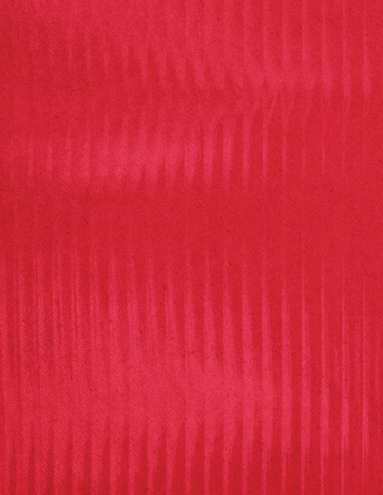 A close-up view of a red fabric with a subtle vertical ribbed texture. Description generated by AI