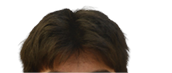 Person with dark, slightly messy hair against a white background. Description generated by AI