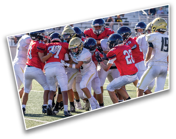 Several people wearing athletic shoes are standing on a sports field with artificial turf. Description generated by AI