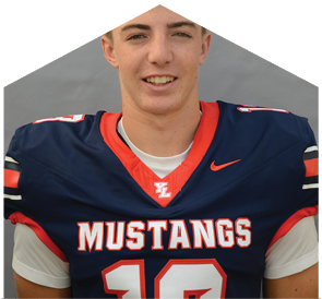 Person wearing a navy blue football jersey with red and white accents and the word Mustangs across the chest. Description generated by AI