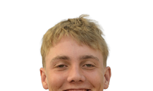 A person with short, tousled blond hair is smiling. Description generated by AI