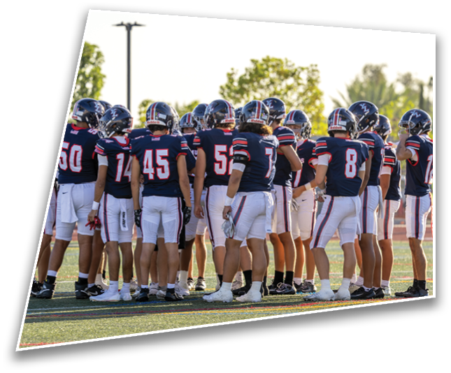 A group of people wearing athletic shorts and cleats are standing together on a sports field. Description generated by AI