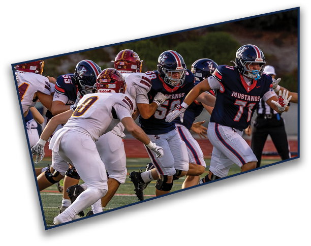 People in football uniforms are actively engaged in a play on a field with one player running while others are blocking or pursuing. Description generated by AI