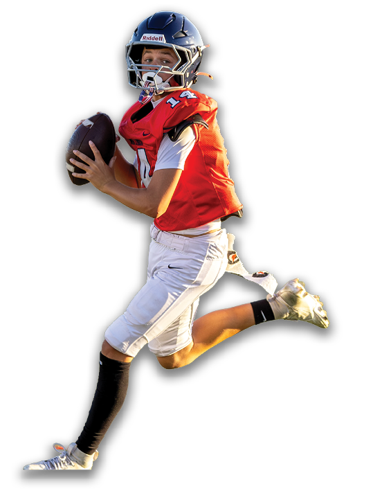A person wearing a football helmet and uniform is running while holding a football in a ready-to-throw position. Description generated by AI