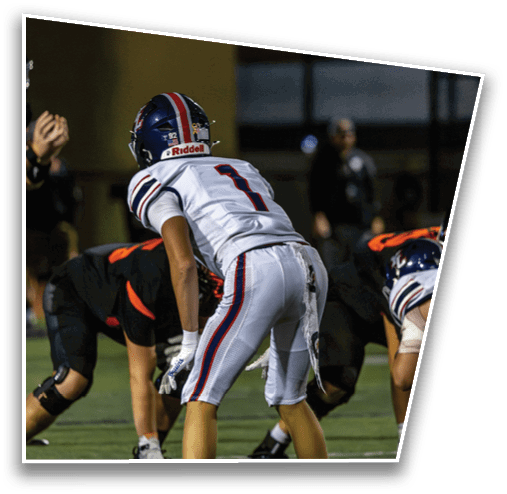 Several people wearing athletic gear and cleats are positioned on a sports field, appearing to prepare for a play or action. Description generated by AI