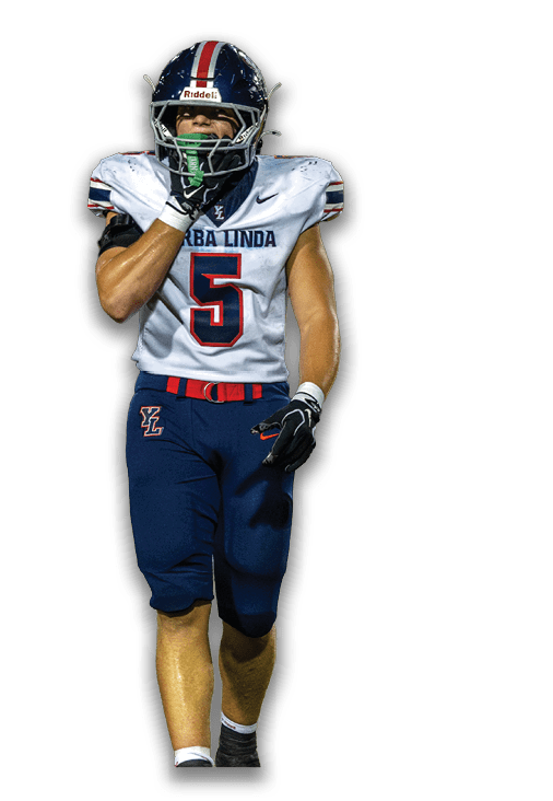 A person wearing a football uniform with the number 5 and the name “Yerba Linda" on the jersey is walking forward with one hand near their face. Description generated by AI