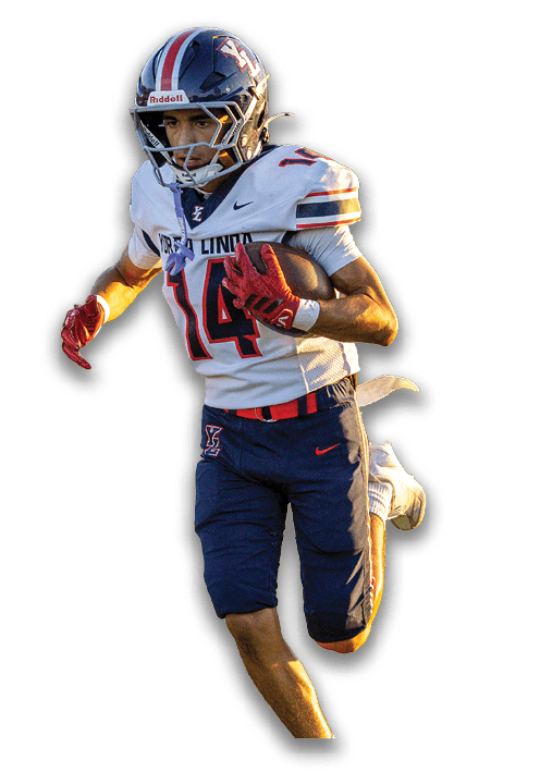 A person wearing a football uniform with the number 14 is running while holding a football. Description generated by AI