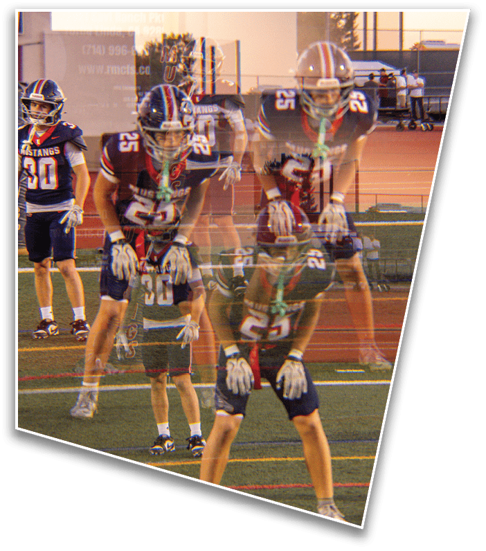 Two people wearing football uniforms and helmets are standing on a field with one person bent forward and the other standing upright behind them, with a blurred double exposure effect. Description generated by AI