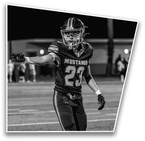 A person wearing a sports uniform with the number 23 is standing on a football field. Description generated by AI