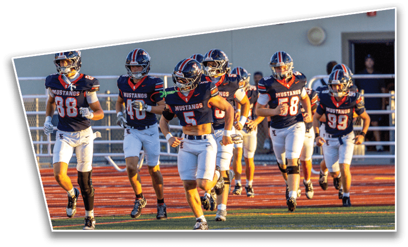 A group of people wearing football uniforms with “Mustangs" on their jerseys are running on a sports field. Description generated by AI