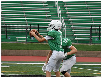 A group of football players on a field. Description generated by AI