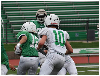 A group of football players on a field. Description generated by AI