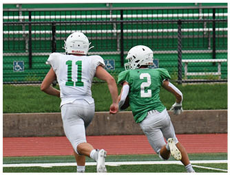 A group of football players on a field. Description generated by AI