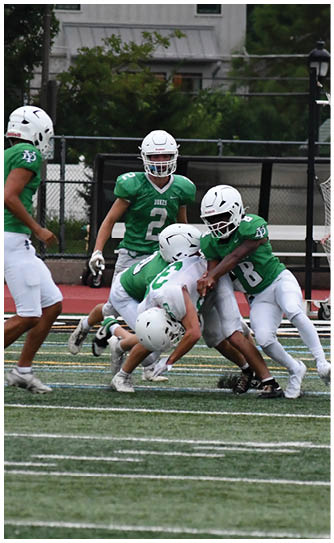 A football player catching a ball. Description generated by AI