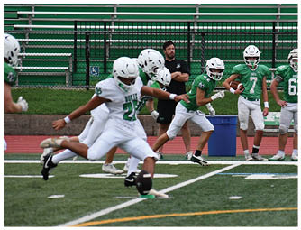 A group of football players on a field. Description generated by AI