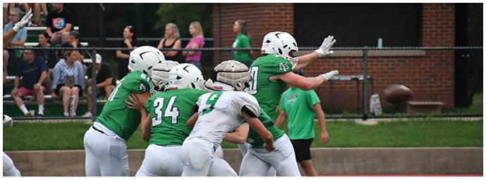 A football player wearing a blue and white uniform. Description generated by AI