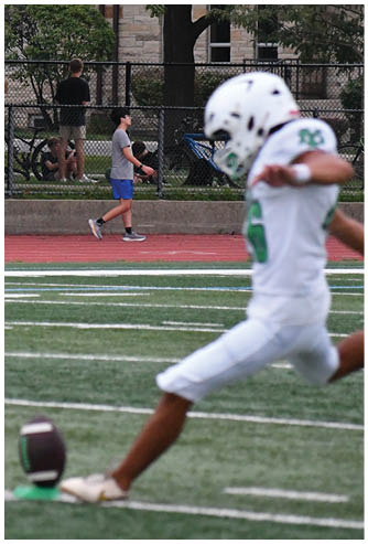 A football game is being played on a field. Description generated by AI