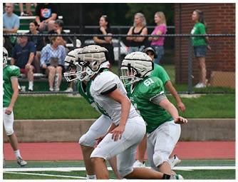 A group of football players on a field. Description generated by AI
