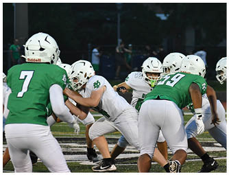 A group of football players on a field. Description generated by AI