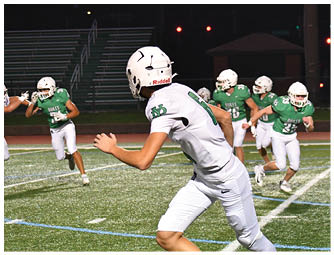 A group of football players on a field. Description generated by AI