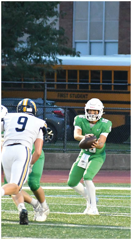 A football player wearing a blue and red jersey. Description generated by AI