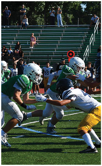 A football player catching a ball. Description generated by AI