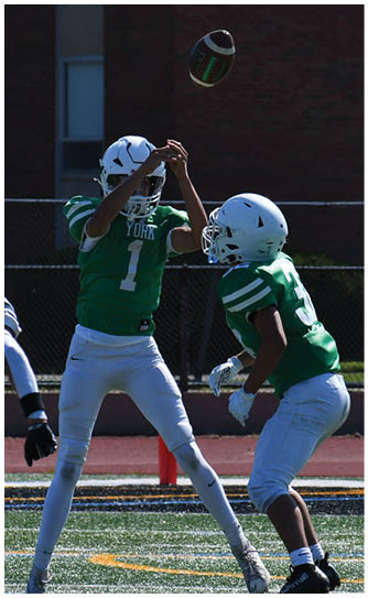 A football player catching a ball. Description generated by AI