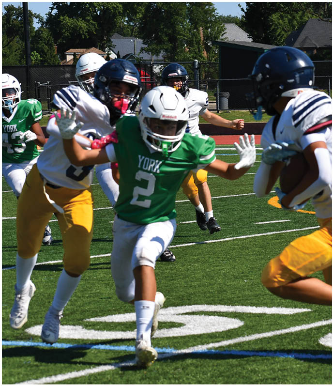 Three football players in blue and white uniforms running on a field. Description generated by AI