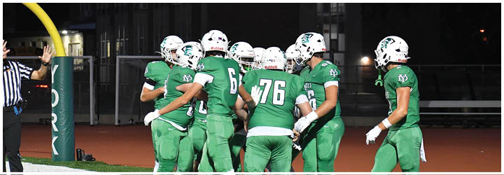 A group of football players on a field. Description generated by AI