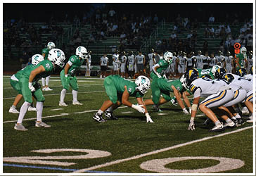 Two football players celebrating on the field. Description generated by AI