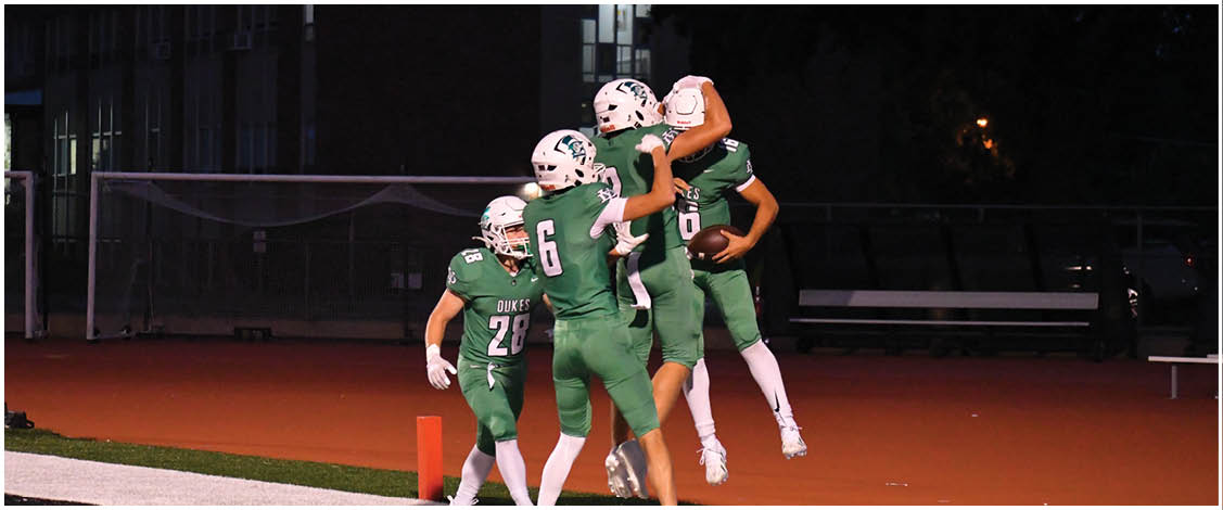 A group of football players on a field. Description generated by AI