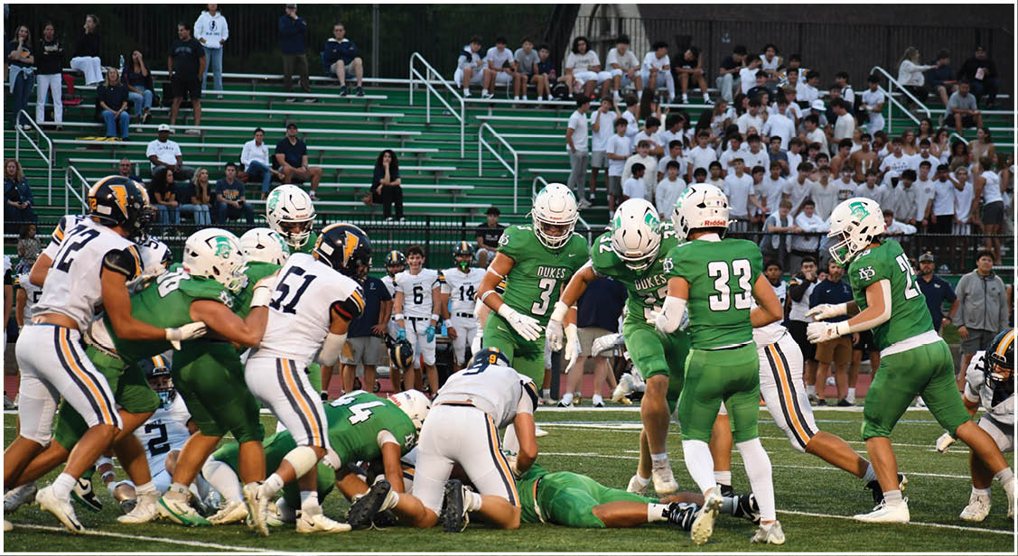A group of football players on a field. Description generated by AI