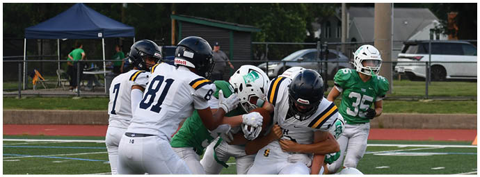 A football player wearing a blue and white uniform. Description generated by AI