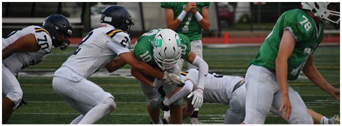 A football player wearing a blue and white uniform. Description generated by AI