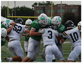 A group of football players on a field. Description generated by AI