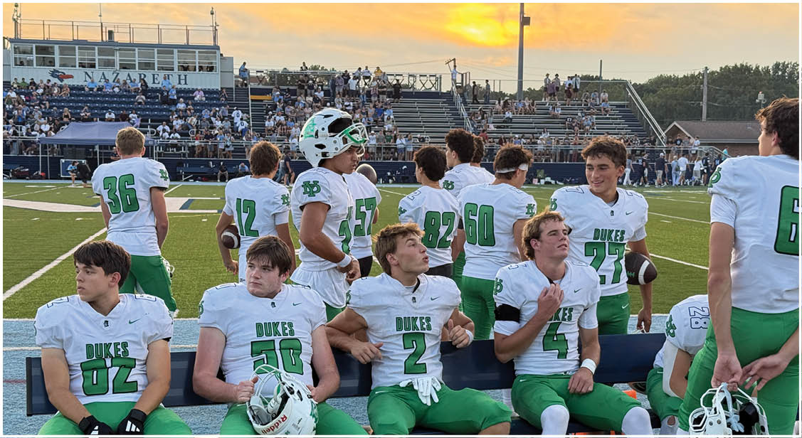 A group of football players on a field. Description generated by AI
