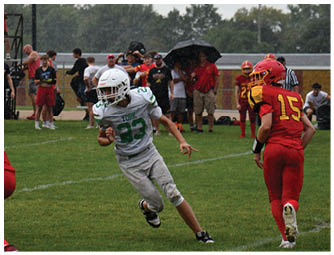 A group of football players on a field. Description generated by AI