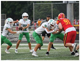 A group of football players on a field. Description generated by AI