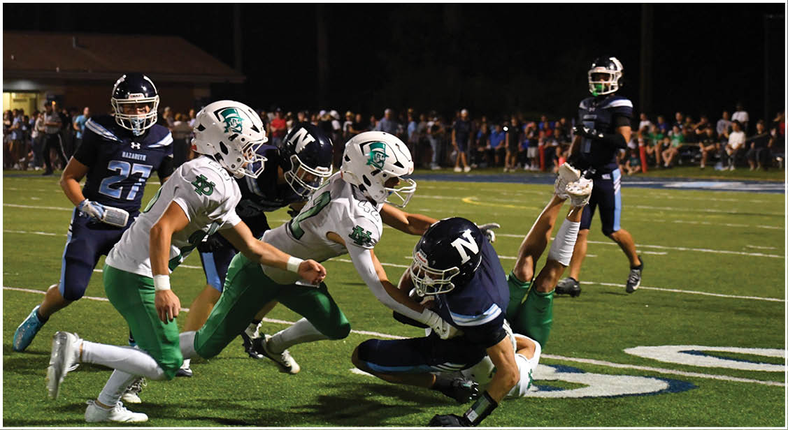 A group of football players on a field. Description generated by AI