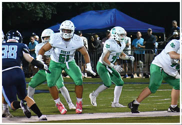 Two football players celebrating on the field. Description generated by AI