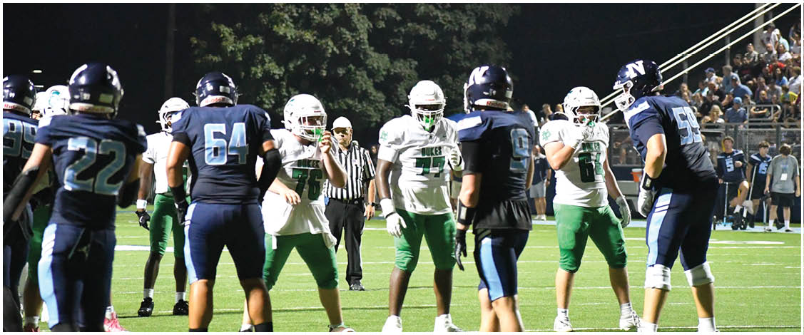 A group of football players on a field. Description generated by AI