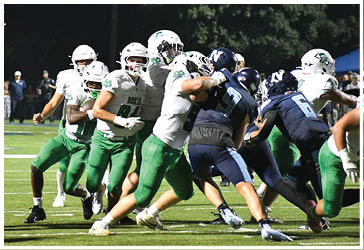 Two football players celebrating on the field. Description generated by AI