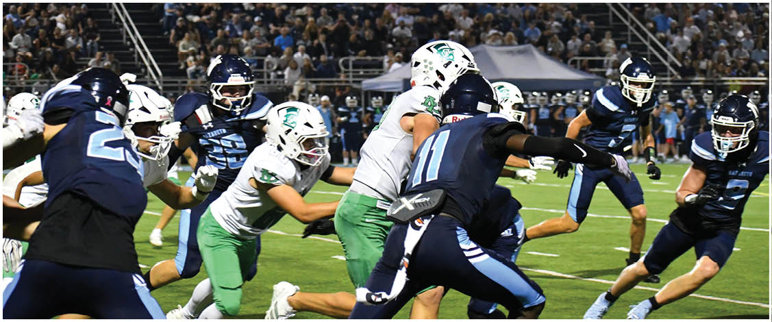 A group of football players on a field. Description generated by AI
