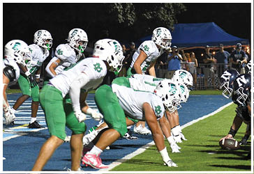 Two football players celebrating on the field. Description generated by AI