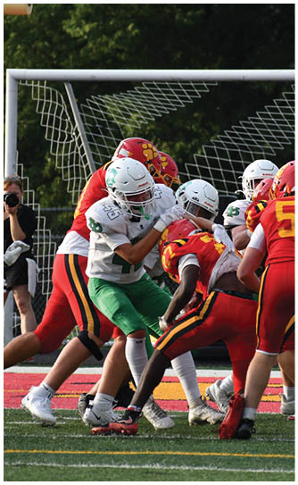 A football player catching a ball. Description generated by AI