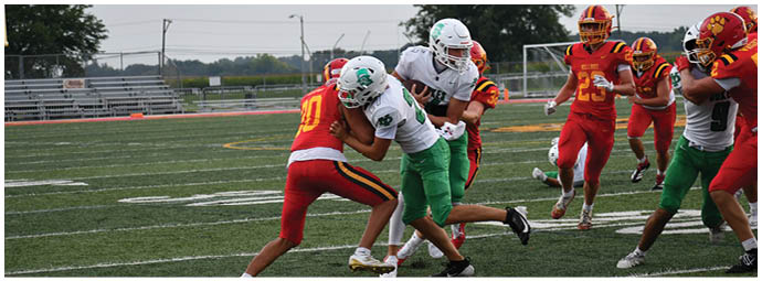 A football player wearing a blue and white uniform. Description generated by AI